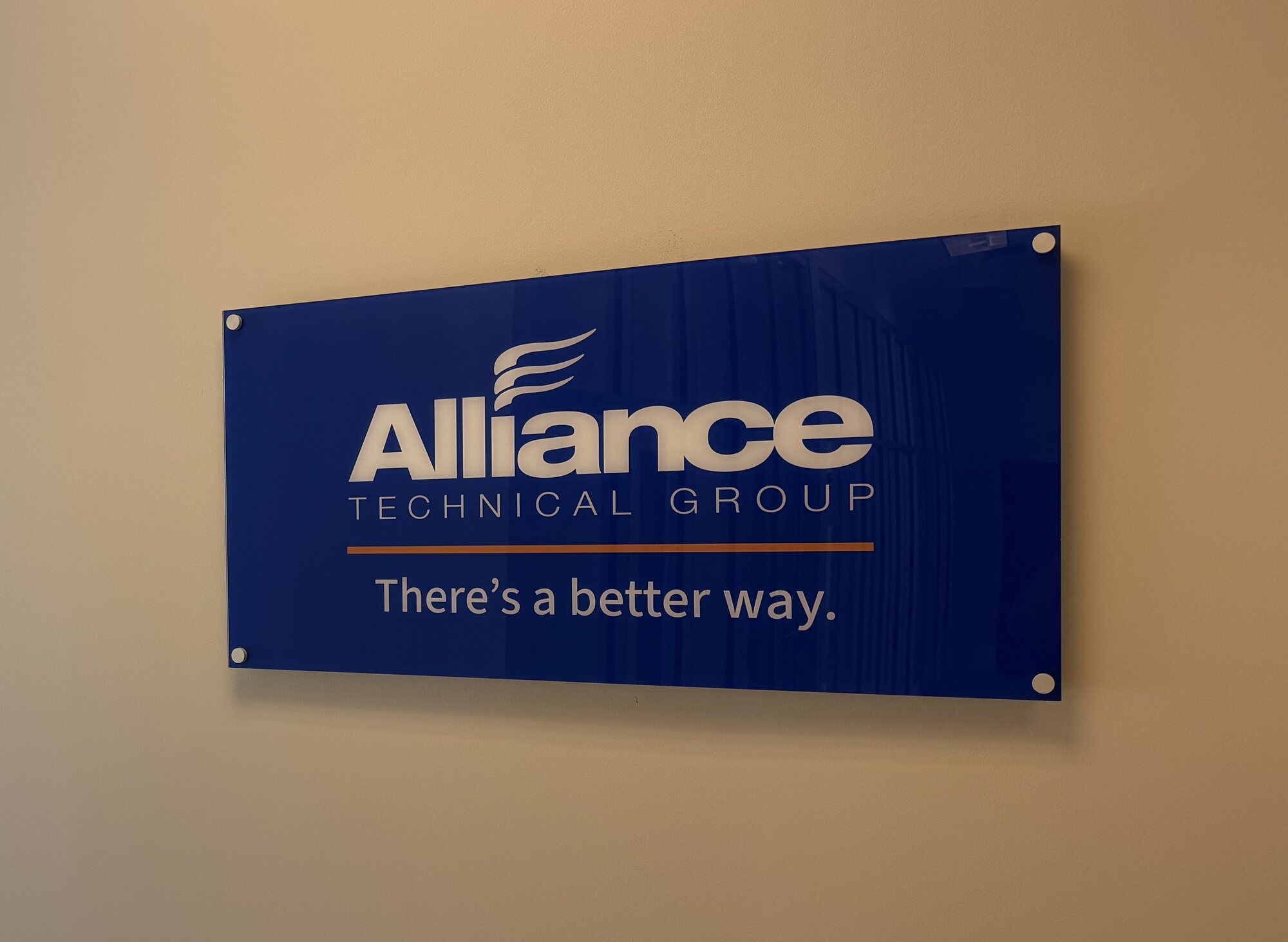 Blue Alliance Technical Group lobby sign reading “There’s a better way.” mounted on a wall with standoffs