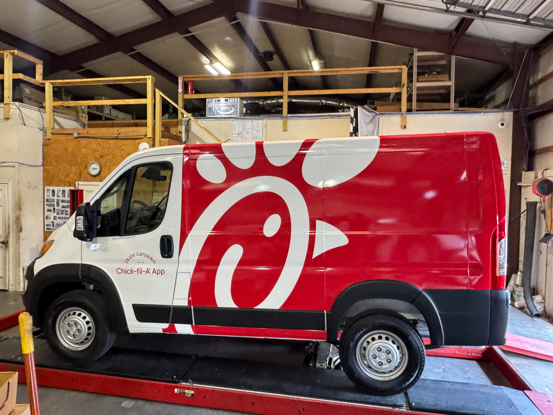 Chick-fil-A delivery van with a full vehicle wrap installed in the shop